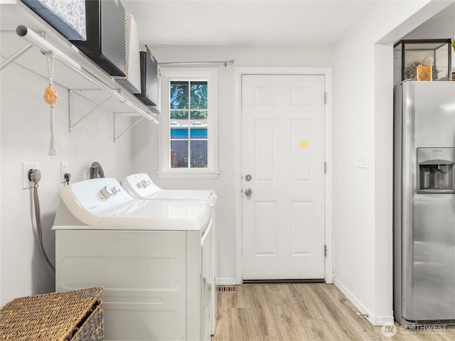 8839 S Yakima Ave, Tacoma, WA 98444 - laundry room with light wood finished floors and washer and clothes dryer