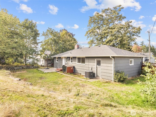 8839 S Yakima Ave, Tacoma, WA 98444 - back of house featuring a yard, a patio area, a shingled roof, and a chimney