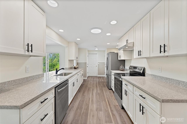 22720 90th Ave W, Edmonds, WA 98026 - kitchen featuring appliances with stainless steel finishes, under cabinet range hood, light wood-style floors, white cabinetry, and recessed lighting