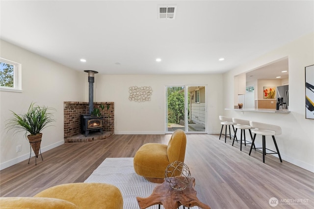 22720 90th Ave W, Edmonds, WA 98026 - living room featuring plenty of natural light, wood finished floors, a wood stove, and recessed lighting
