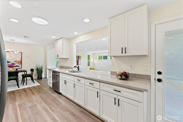 22720 90th Ave W, Edmonds, WA 98026 - kitchen with stainless steel dishwasher, light wood-style floors, white cabinets, recessed lighting, and light stone countertops
