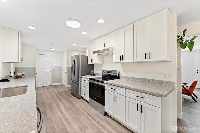 22720 90th Ave W, Edmonds, WA 98026 - kitchen featuring appliances with stainless steel finishes, under cabinet range hood, light wood-style floors, white cabinetry, and recessed lighting
