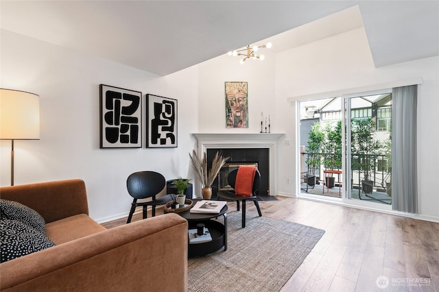 1926 Fairview Ave E Unit 307, Seattle, WA 98102 - living area featuring wood finished floors, a chandelier, and a tiled fireplace