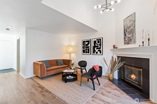 1926 Fairview Ave E Unit 307, Seattle, WA 98102 - living area featuring wood finished floors, a fireplace, and a chandelier
