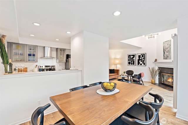 1926 Fairview Ave E Unit 307, Seattle, WA 98102 - dining space featuring light wood-style floors, a fireplace with flush hearth, and recessed lighting