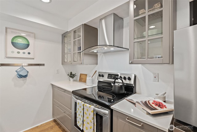 1926 Fairview Ave E Unit 307, Seattle, WA 98102 - kitchen with stainless steel appliances, gray cabinetry, wall chimney exhaust hood, and light countertops