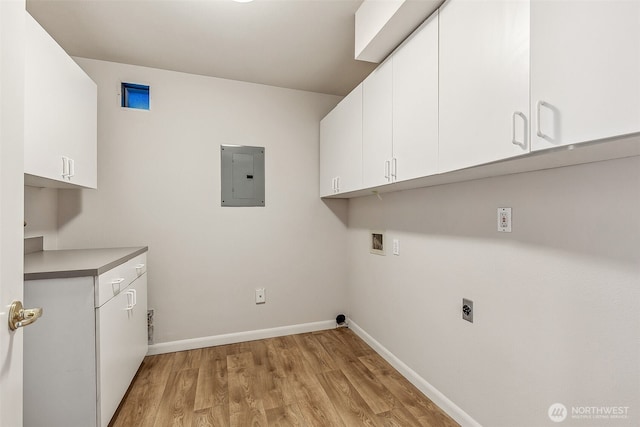 1300 Alki Ave SW Unit 100, Seattle, WA 98116 - washroom with electric panel, hookup for a washing machine, cabinet space, light wood-type flooring, and electric dryer hookup