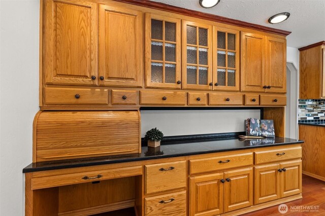 3322 Pacific Way, Longview, WA 98632 - kitchen featuring brown cabinets, dark countertops, and glass insert cabinets