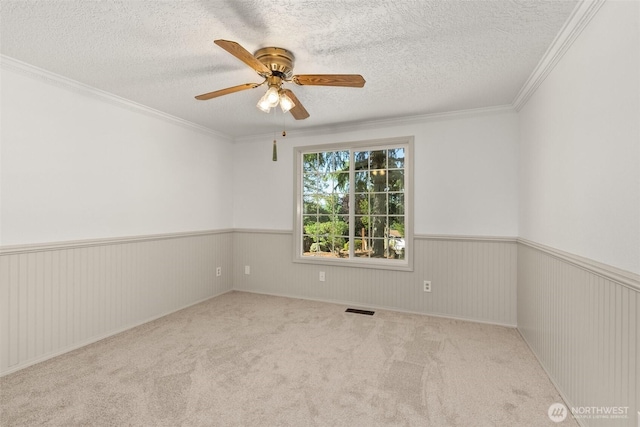 3322 Pacific Way, Longview, WA 98632 - spare room with a textured ceiling, a ceiling fan, carpet, crown molding, and wainscoting