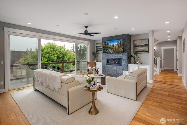 921 Whitewater Dr, Bellingham, WA 98229 - living room with a stone fireplace, light wood-style floors, ceiling fan, and recessed lighting