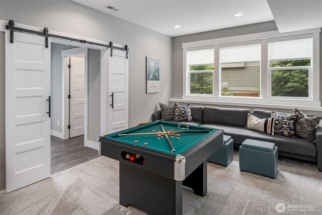 921 Whitewater Dr, Bellingham, WA 98229 - recreation room with a barn door, carpet flooring, recessed lighting, and wood finished floors