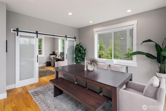 921 Whitewater Dr, Bellingham, WA 98229 - dining space featuring a barn door, recessed lighting, light wood-style floors, and an office area