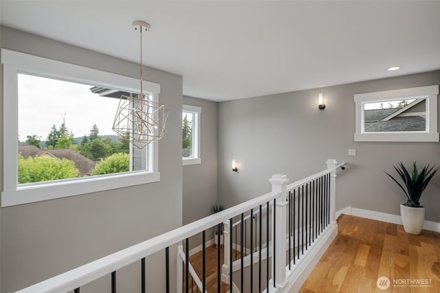 921 Whitewater Dr, Bellingham, WA 98229 - corridor with a chandelier, an upstairs landing, light wood finished floors, and recessed lighting