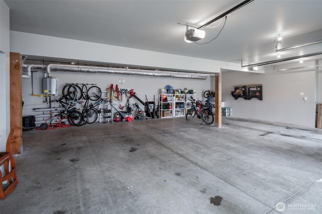 921 Whitewater Dr, Bellingham, WA 98229 - garage featuring gas water heater, a garage door opener, and bike storage
