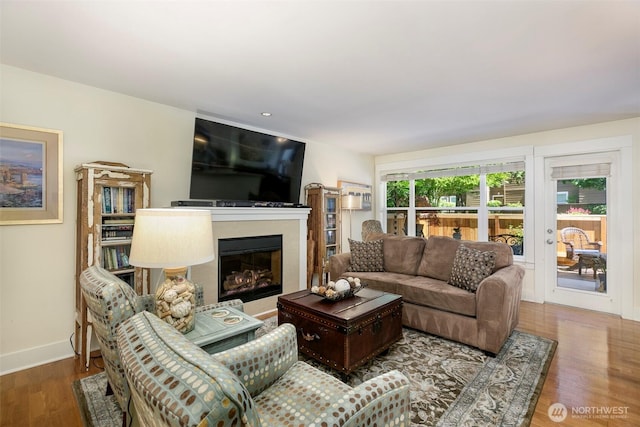 22910 90th Ave W Unit C103, Edmonds, WA 98026 - living room featuring a glass covered fireplace, wood finished floors, and recessed lighting