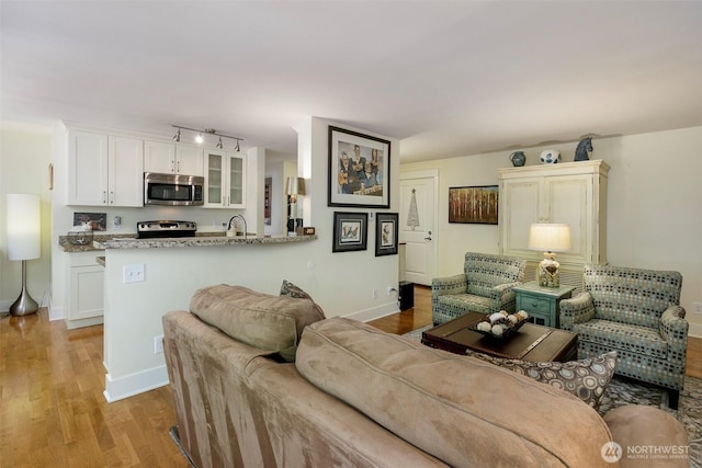 22910 90th Ave W Unit C103, Edmonds, WA 98026 - living room with light wood finished floors and baseboards