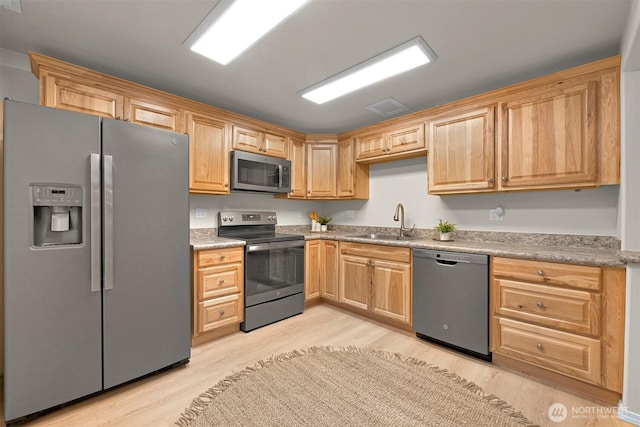 8894 Giles Rd, Blaine, WA 98230 - kitchen with appliances with stainless steel finishes, light wood-style floors, light brown cabinets, and light countertops