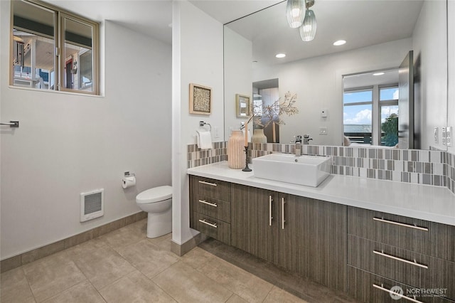 1706 Alki Ave SW Unit A, Seattle, WA 98116 - bathroom featuring vanity, heating unit, and decorative backsplash