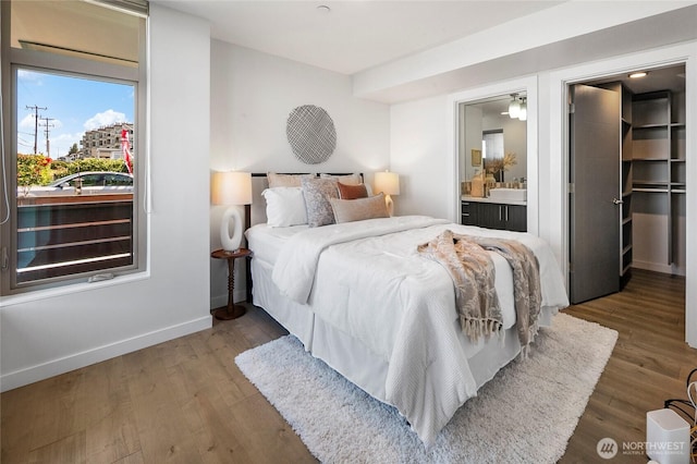 1706 Alki Ave SW Unit A, Seattle, WA 98116 - bedroom featuring a spacious closet, wood finished floors, and ensuite bath