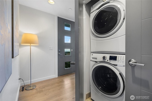 1706 Alki Ave SW Unit A, Seattle, WA 98116 - laundry room featuring stacked washing machine and dryer, light wood-style flooring, and recessed lighting