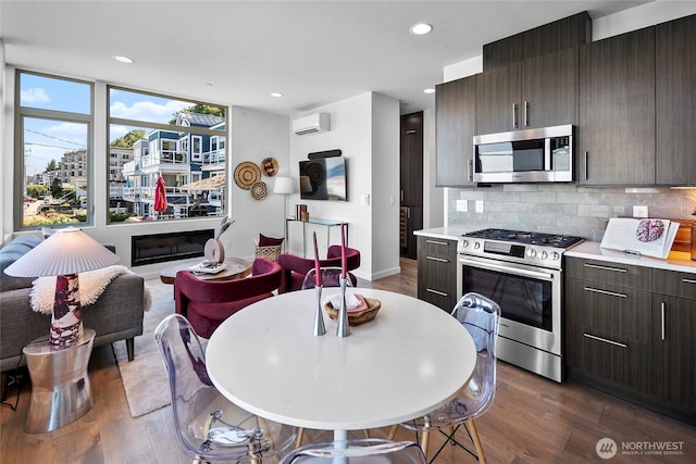 1706 Alki Ave SW Unit A, Seattle, WA 98116 - kitchen featuring appliances with stainless steel finishes, dark wood-type flooring, dark brown cabinetry, light countertops, and tasteful backsplash
