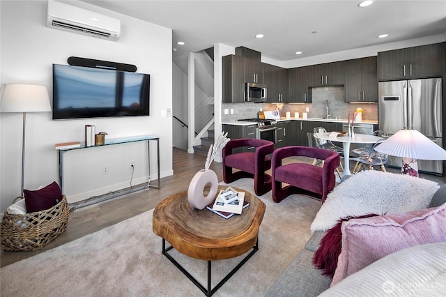 1706 Alki Ave SW Unit A, Seattle, WA 98116 - living area with a wall unit AC, recessed lighting, light wood-style flooring, and stairway