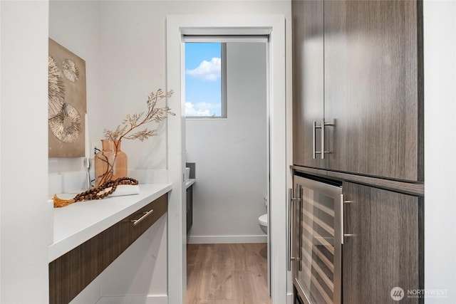 1706 Alki Ave SW Unit A, Seattle, WA 98116 - bathroom with wine cooler, wood finished floors, and vanity