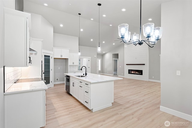 821 174th Ave NW, Lakebay, WA 98349 - kitchen with stainless steel dishwasher, a chandelier, white cabinets, high vaulted ceiling, and light wood-style floors