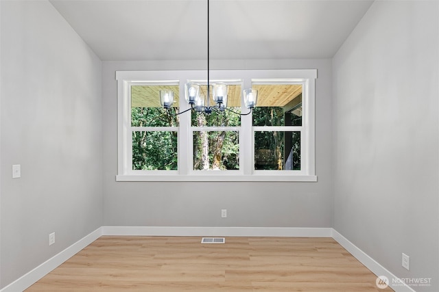 821 174th Ave NW, Lakebay, WA 98349 - unfurnished dining area featuring a chandelier and light wood-style flooring