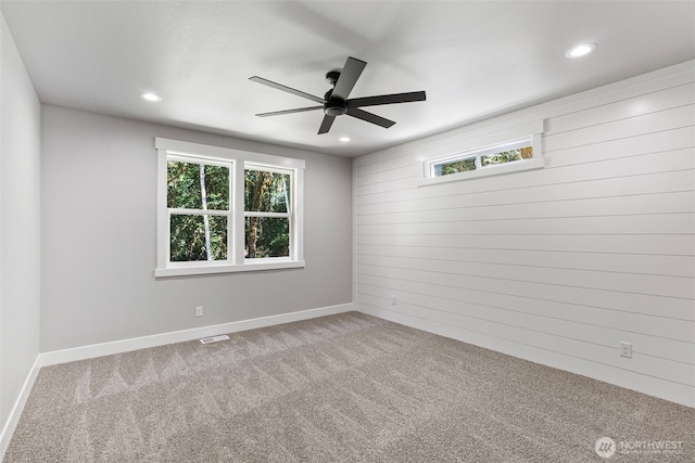 821 174th Ave NW, Lakebay, WA 98349 - spare room with carpet, ceiling fan, healthy amount of natural light, wood walls, and recessed lighting