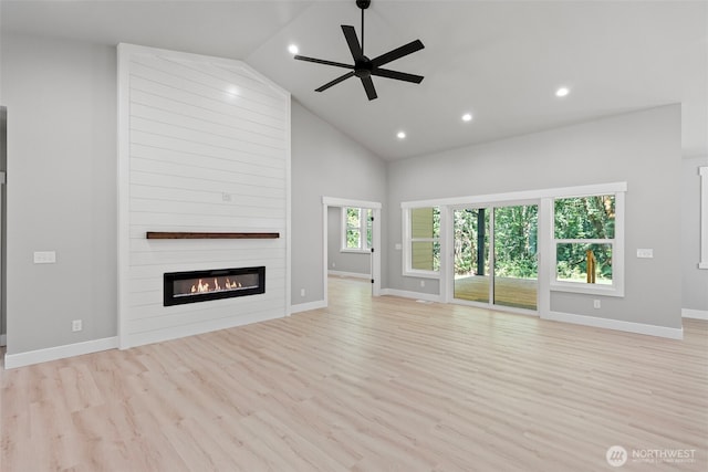 821 174th Ave NW, Lakebay, WA 98349 - unfurnished living room featuring light wood-style flooring, recessed lighting, a large fireplace, ceiling fan, and high vaulted ceiling