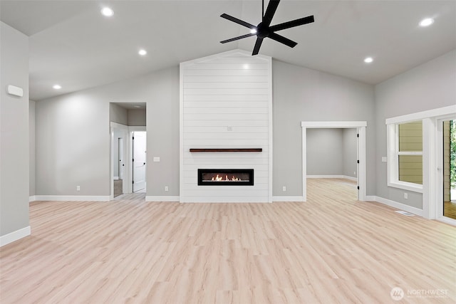 821 174th Ave NW, Lakebay, WA 98349 - unfurnished living room with vaulted ceiling, ceiling fan, light wood-style flooring, a fireplace, and recessed lighting