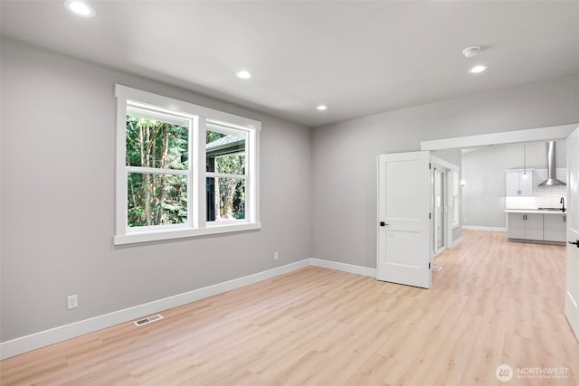 821 174th Ave NW, Lakebay, WA 98349 - unfurnished living room featuring light wood-style floors and recessed lighting
