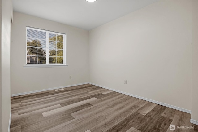 8618 217th Pl NE, Arlington, WA 98223 - spare room featuring wood finished floors and baseboards