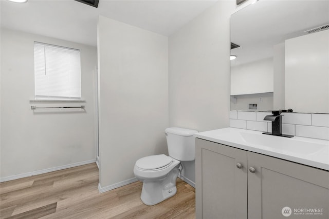 8618 217th Pl NE, Arlington, WA 98223 - bathroom featuring wood finished floors, vanity, and decorative backsplash