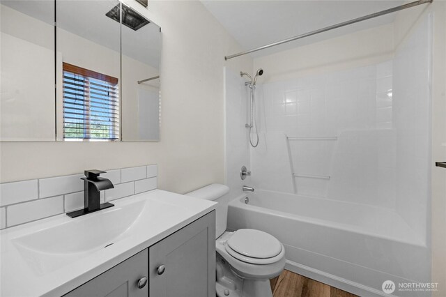 8618 217th Pl NE, Arlington, WA 98223 - full bathroom featuring washtub / shower combination, vanity, wood finished floors, and decorative backsplash
