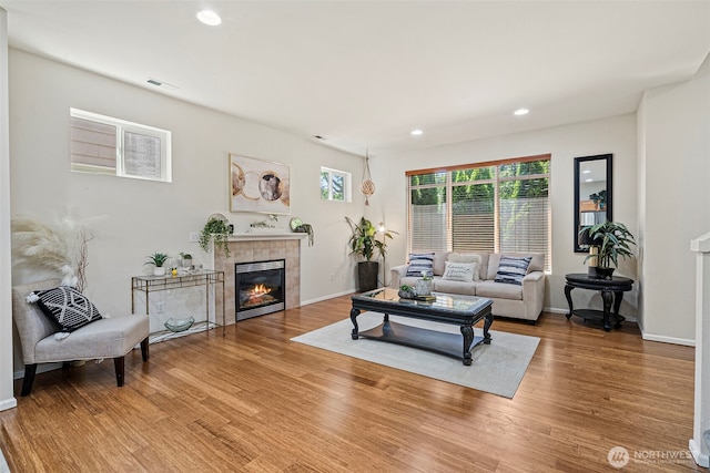4318 3rd Ave NW, Olympia, WA 98502 - living room featuring wood finished floors, a tiled fireplace, and recessed lighting