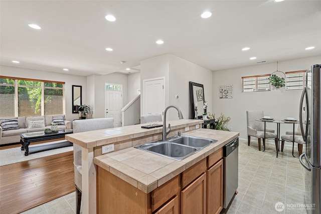 4318 3rd Ave NW, Olympia, WA 98502 - kitchen featuring appliances with stainless steel finishes, tile counters, recessed lighting, a kitchen island with sink, and open floor plan