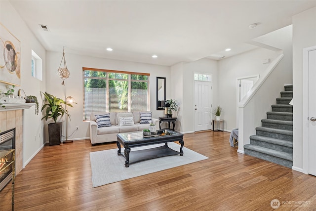 4318 3rd Ave NW, Olympia, WA 98502 - living room featuring stairway, wood finished floors, recessed lighting, and a tiled fireplace