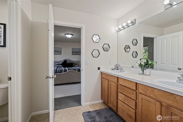 4318 3rd Ave NW, Olympia, WA 98502 - ensuite bathroom featuring double vanity and baseboards