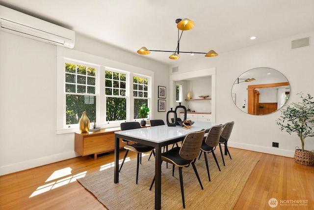 109 E Roanoke St, Seattle, WA 98102 - dining room with a wall unit AC, light wood-style flooring, and recessed lighting