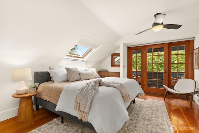 109 E Roanoke St, Seattle, WA 98102 - bedroom featuring access to outside, wood finished floors, a skylight, ceiling fan, and vaulted ceiling