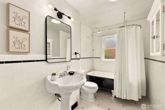 109 E Roanoke St, Seattle, WA 98102 - full bath featuring tile walls, shower / tub combo with curtain, tile patterned flooring, and wainscoting
