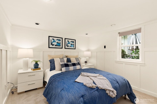 109 E Roanoke St, Seattle, WA 98102 - bedroom featuring a decorative wall, light carpet, and a wainscoted wall