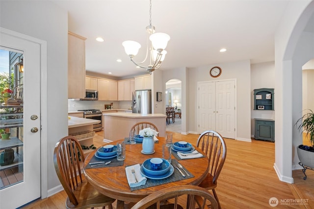1402 Langara Cir, Bellingham, WA 98229 - dining room with arched walkways, a chandelier, light wood-type flooring, and recessed lighting