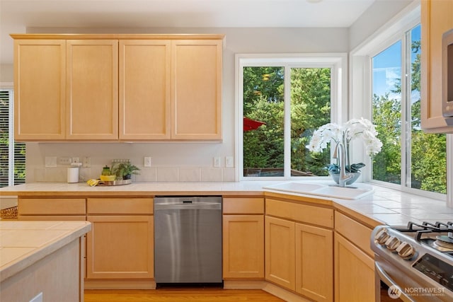 1402 Langara Cir, Bellingham, WA 98229 - kitchen featuring dishwasher, tile counters, light brown cabinets, and light wood-style flooring