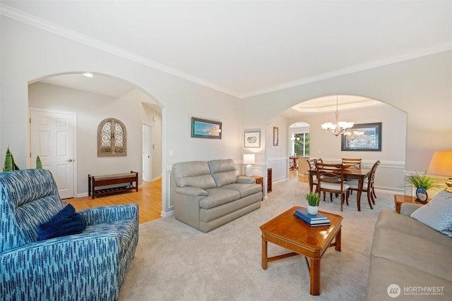 1402 Langara Cir, Bellingham, WA 98229 - living area featuring arched walkways, crown molding, a chandelier, and light carpet