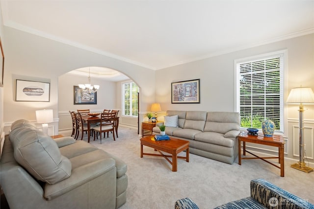 1402 Langara Cir, Bellingham, WA 98229 - living area with crown molding, arched walkways, light carpet, and a chandelier