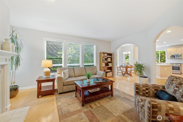 1402 Langara Cir, Bellingham, WA 98229 - living area featuring arched walkways, light wood finished floors, and recessed lighting