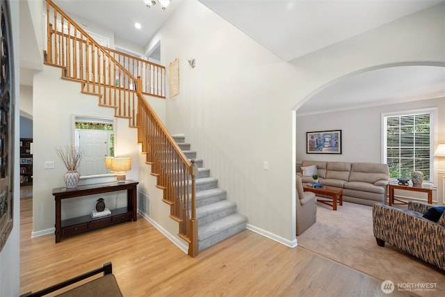 1402 Langara Cir, Bellingham, WA 98229 - stairs featuring arched walkways, wood finished floors, recessed lighting, and crown molding